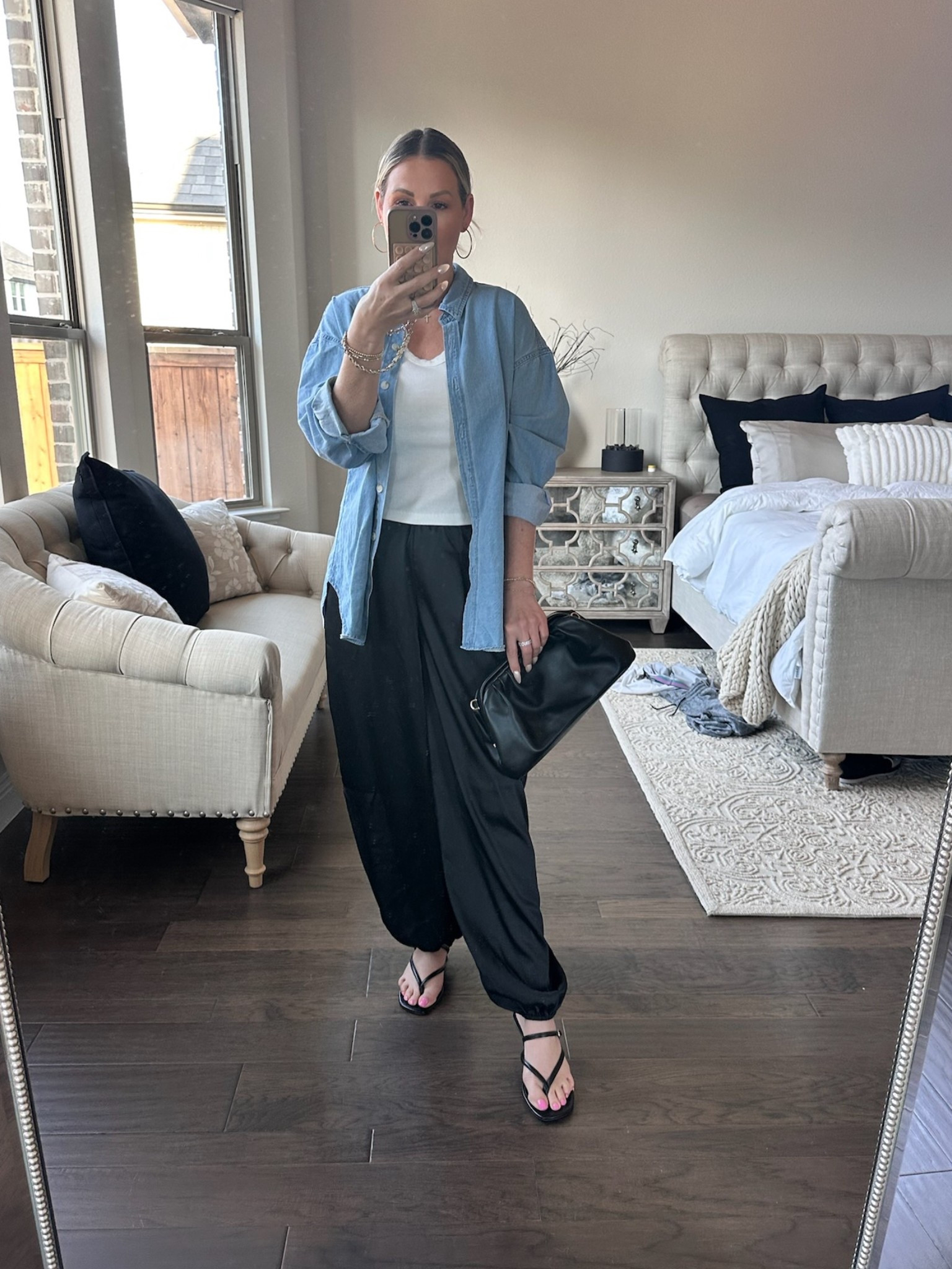Coffee runs and pedicure plans with my girls🩷

This is exactly the kind of outfit I reach for during spring break - easy, comfortable, but still feeling put together for real life moments.
Relaxed black pants, a simple white tank, and an oversized chambray button-down layered on top for that effortless, slightly undone feel. It's one of those combinations that always works.

The strappy sandals keep it minimal and feminine, and the black clutch adds just enough polish to take it from casual to styled.

Simple pieces, styled intentionally - because polished doesn't have to feel complicated.

Everything linked for you⬆️

#everydayelevated #over40style #effortlessstyle #springoutfits #highlowfashion

#LTKgrwm #LTKSeasonal #LTKootd