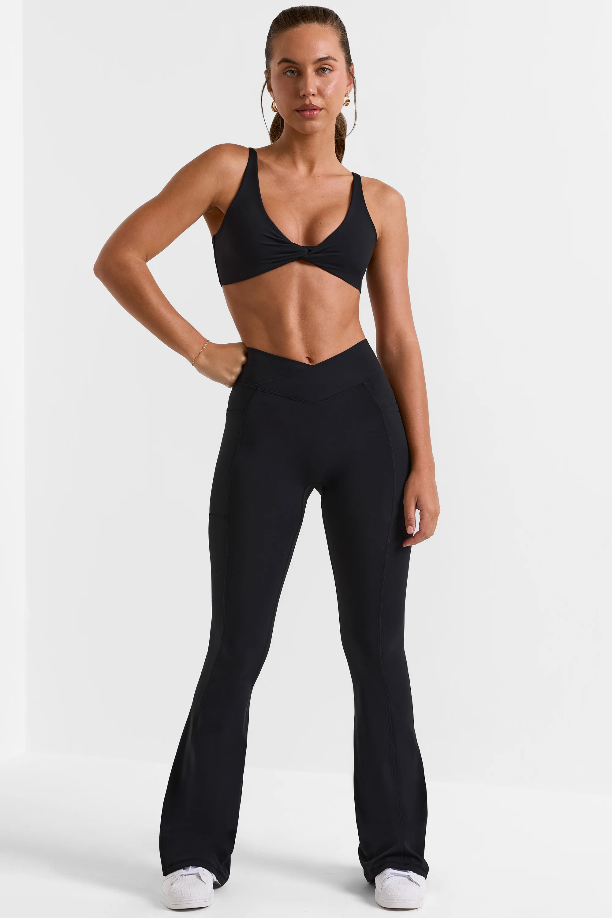 Cross Waistband Flare Pocket Leggings in Black | Oh Polly