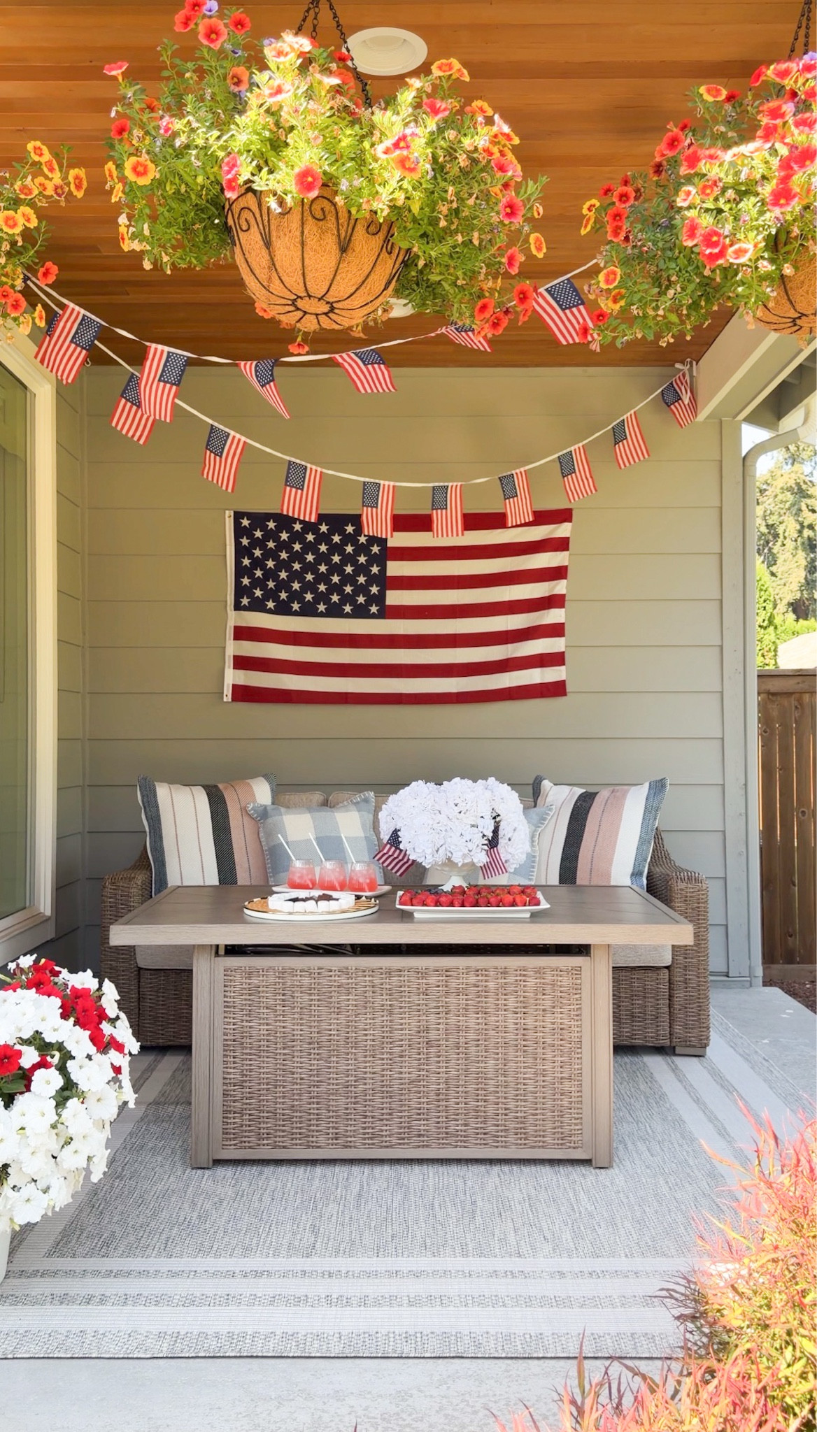 July 4th patriotic front porch outdoor furniture set up! USA American flag garland with fire pit patio table! 

Fire pit table, straws, plate, tray, pillows, rug, flag picks, bud vases, hanging basket, outdoor sofa, glasses, vases, hydrangeas, American Flag banner

#LTKfestival #LTKhome #LTKsummer