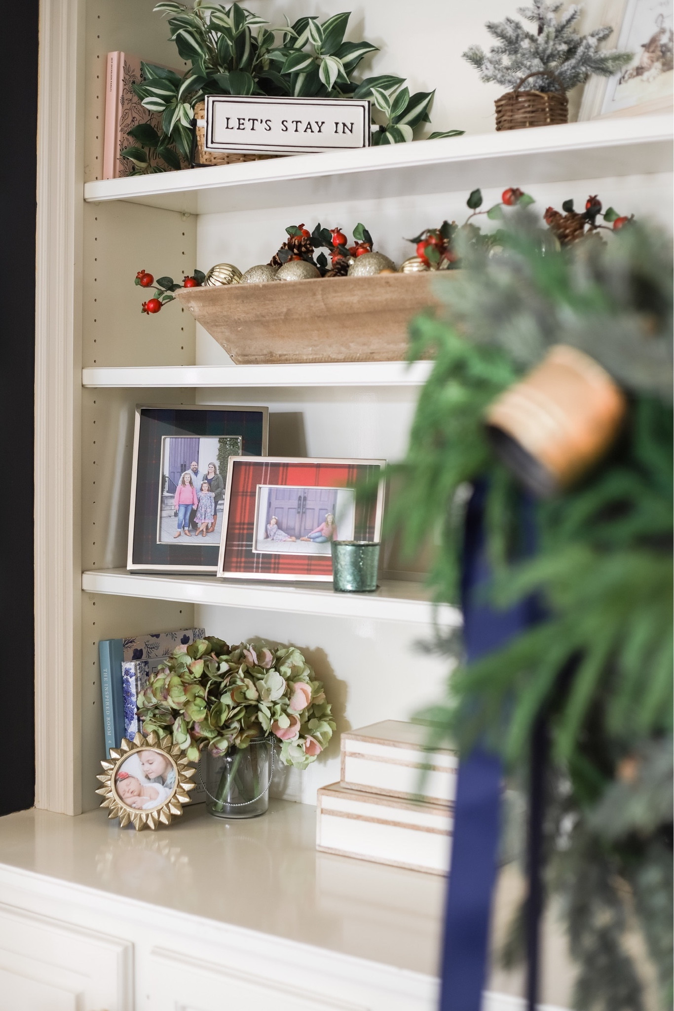 An ornament-filled dough bowl and plaid picture frames bring a little Christmas cheer to my living room book shelves!

#LTKSeasonal #LTKhome