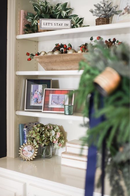 An ornament-filled dough bowl and plaid picture frames bring a little Christmas cheer to my living room book shelves!

#LTKSeasonal #LTKhome