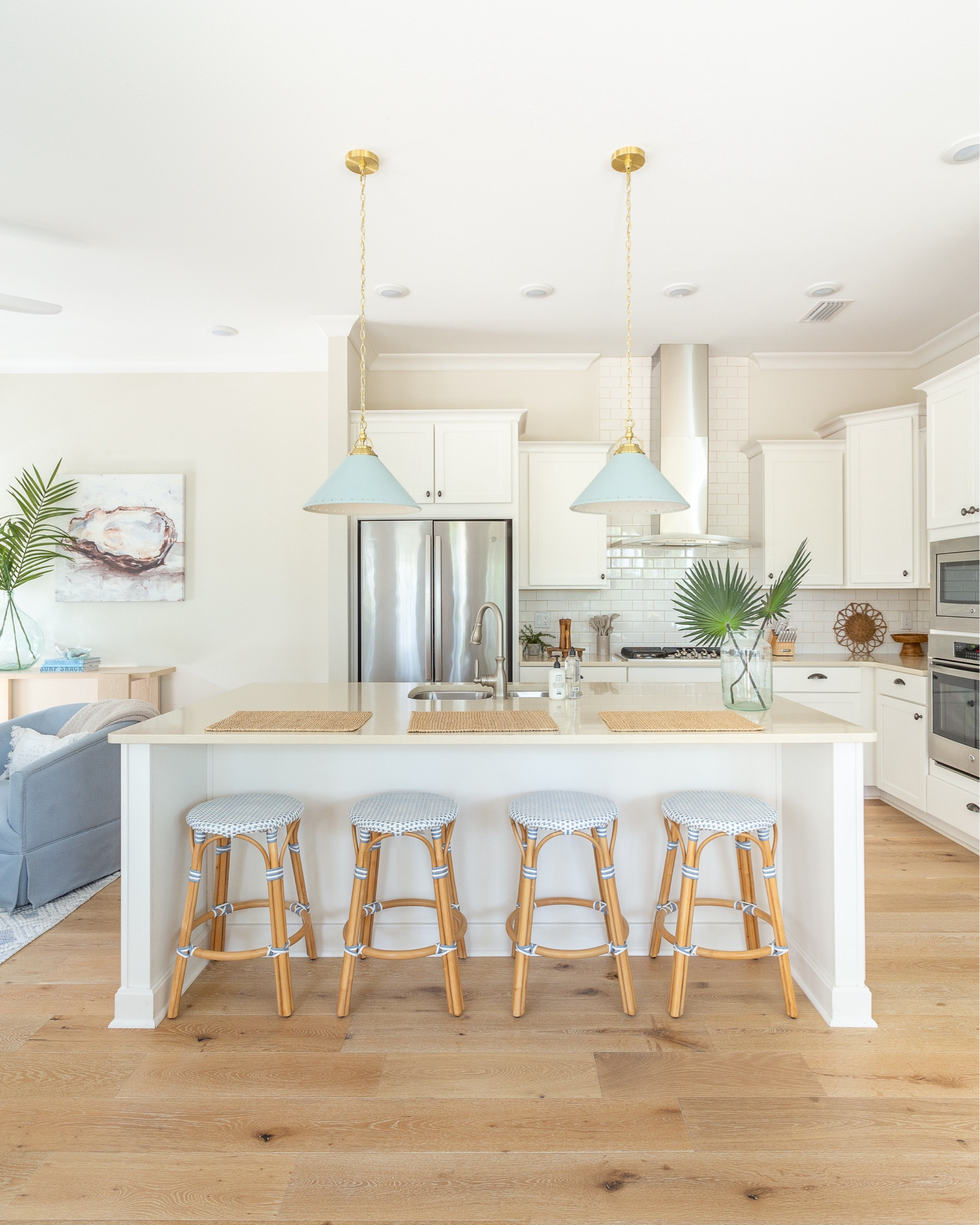 COASTAL KITCHEN - Kitchen and living room details at Hola Beaches Casita! We love these designer look-for-less counter stools with the bamboo legs and woven blue and white seat! They look so cute paired with these light blue pendant lights and faux palm stems. Also linking our oyster art, blue and white rug, bamboo coffee table, rattan TV cabinets and more! See more of the space and full tour here: https://lifeonvirginiastreet.com/hola-beaches-casita-30a-tour/.
.
#ltkhome #ltkseasonal #ltksalealert #ltkfindsunder50 #ltkfindsunder100 #ltkstyletip

#LTKSeasonal #LTKSaleAlert #LTKHome