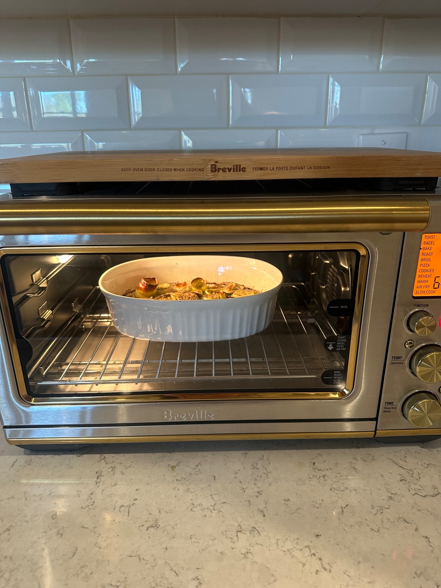 By far, the most-used appliance in our kitchen. Loving the new brass details on this exclusive version 🤩 (I’ve had our original one for close to 15 years) 
This new one truly does it all… even has an air fry option. I use it far more often for baking than our regular oven. It cooks evenly, preheats super fast, and has a huge capacity. 

#LTKHome
