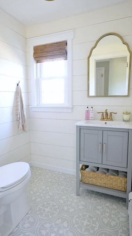 Bathroom renovation powder room, shiplap, gray vanity, brass fixtures, wicker window shades, gray pattern tile, farmhouse, coastal style home decor 

#LTKhome #LTKfamily