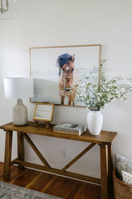 In our entryway we have a wood console table, concrete table lamp, artwork, faux flowers, a white vase and affordable Loloi area rug  

#LTKFind #LTKhome #LTKstyletip
