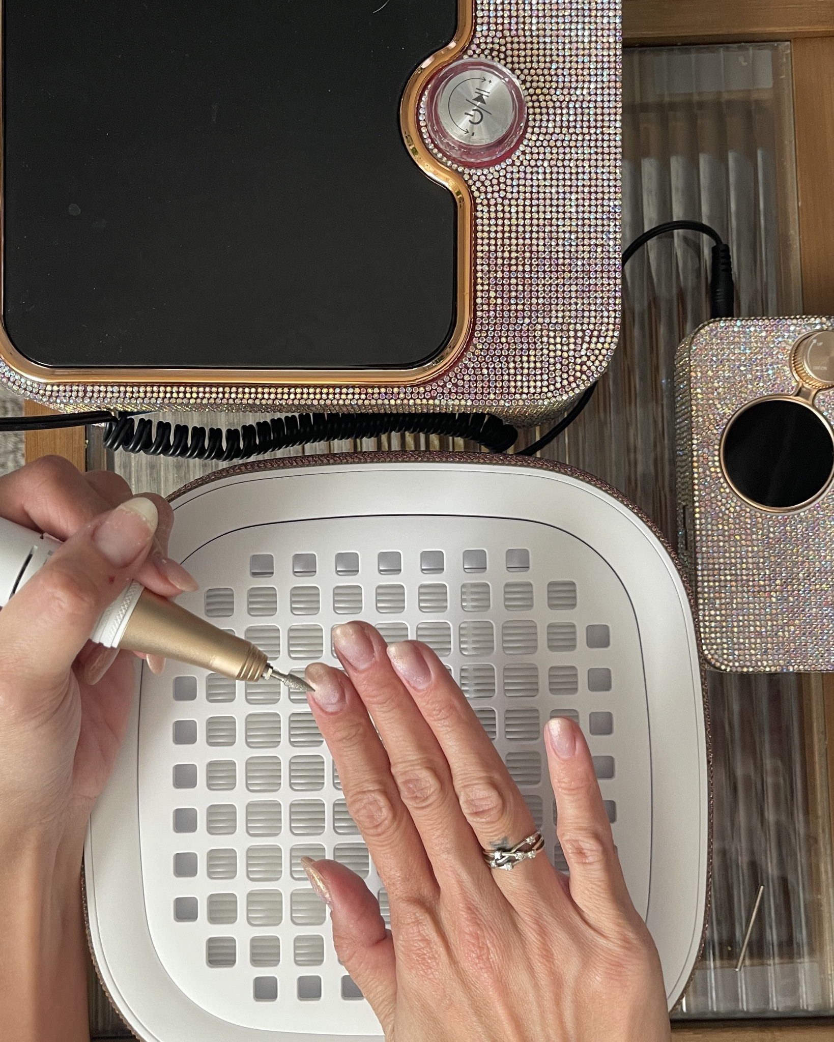 Since I’m my own nail lady, I made sure to get myself in for a fill. (I am not a nail tech, I just love to treat myself to an at-home manicure.)💅🏽 

I started by using the cordless e-file to remove the existing gel nail color from my nails, but leaving the builder gel on. Then, I cleaned up the cuticle area, making sure not to slip on this crucial step of nail prep. Once my nails were fully prepped, I moved on with the manicure. 

I apply base coat to the bare nail area, being sure not to touch the skin with the product. Fully cure with a UV LED nail lamp between each coat of builder get and then applied cat-eye nail polish.  ✨🪩 cateye nail color it gives it the fun nail art vibe without any art skills required. I finish with a clear topcoat, cure,  then wash my hands and apply cuticle oil. 

Style tip- keep your manicure looking fresh by keeping a cuticle oil stick / pen  handy so your manicure stays looking fresh! 

#LTKStyleTip #LTKFindsUnder100 #LTKBeauty