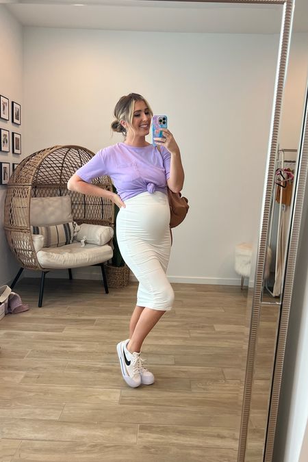 Ruched midi dress from Amazon- it is bump friendly and super stretchy. Comes in multiple colors. I am wearing nude shorts underneath. Tee is an Amazon find and fun for layering over a dress, workout clothes, etc  Both run TTS. Nikes are an NSale find and run TTS as well. 

Amazon 
Maternity Midi
Nike 
NSale 
White Dress

#LTKFind #LTKstyletip #LTKsalealert
