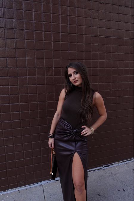 Brown is the new black. Black monochrome look with this chic leather pencil skirt and a sexy slit. Paired with boots but heels would work great too. Makes for an effortless holiday outfit