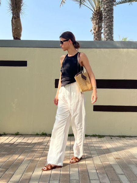 Summer outfit idea: white linen trousers, black linen top, raffia tote bag, caramel sandals

#LTKtravel #LTKeurope #LTKSeasonal