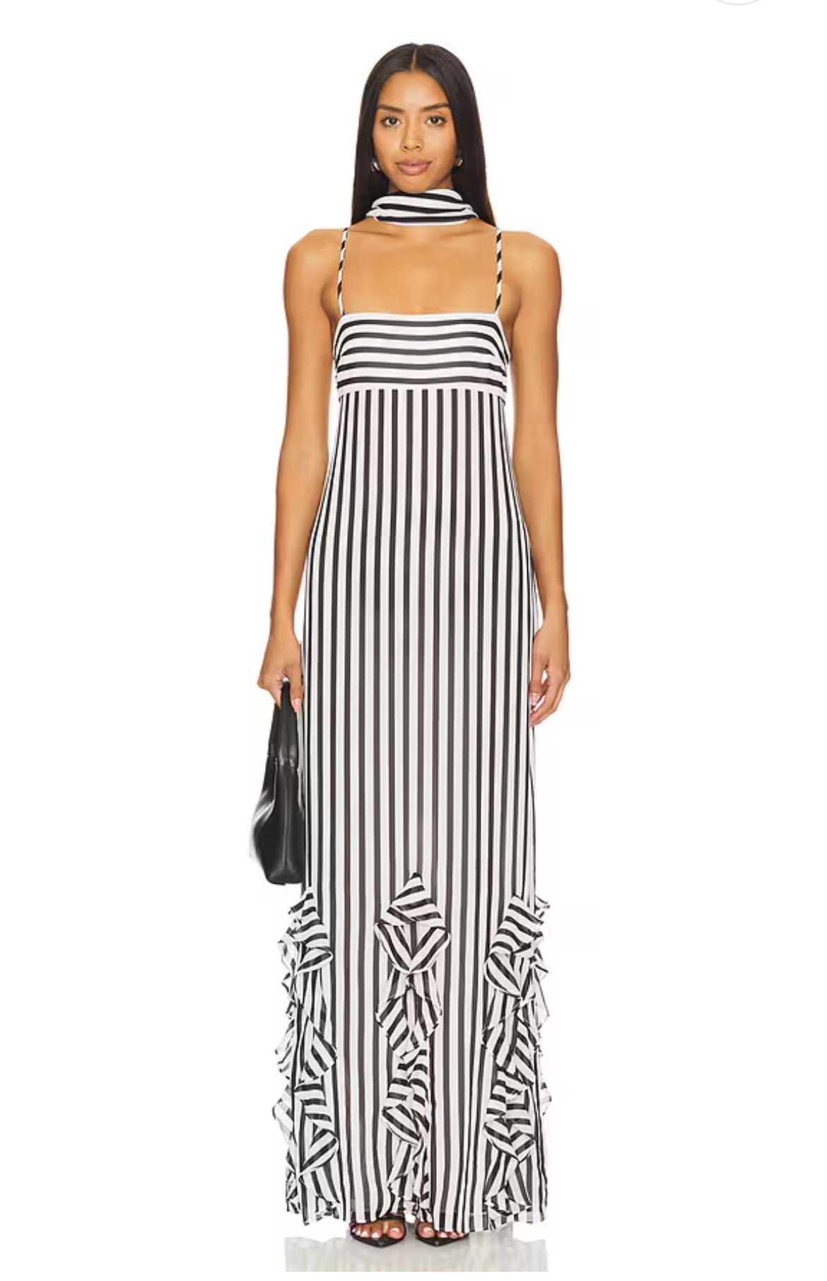 Back in stock! This stunning black and white striped maxi dress from Revolve is finally available again. I love how the vertical stripes elongate the silhouette, while the ruffle hem adds just the right touch of drama. Perfect for wedding guest dress, summer nights, vacations, or chic city dinners.

Paired here with simple black accessories for a timeless look, but it also works beautifully with bold pops of color.

I’ve linked this exact dress along with some gorgeous similar striped maxi dresses and statement black & white gowns you’ll love.