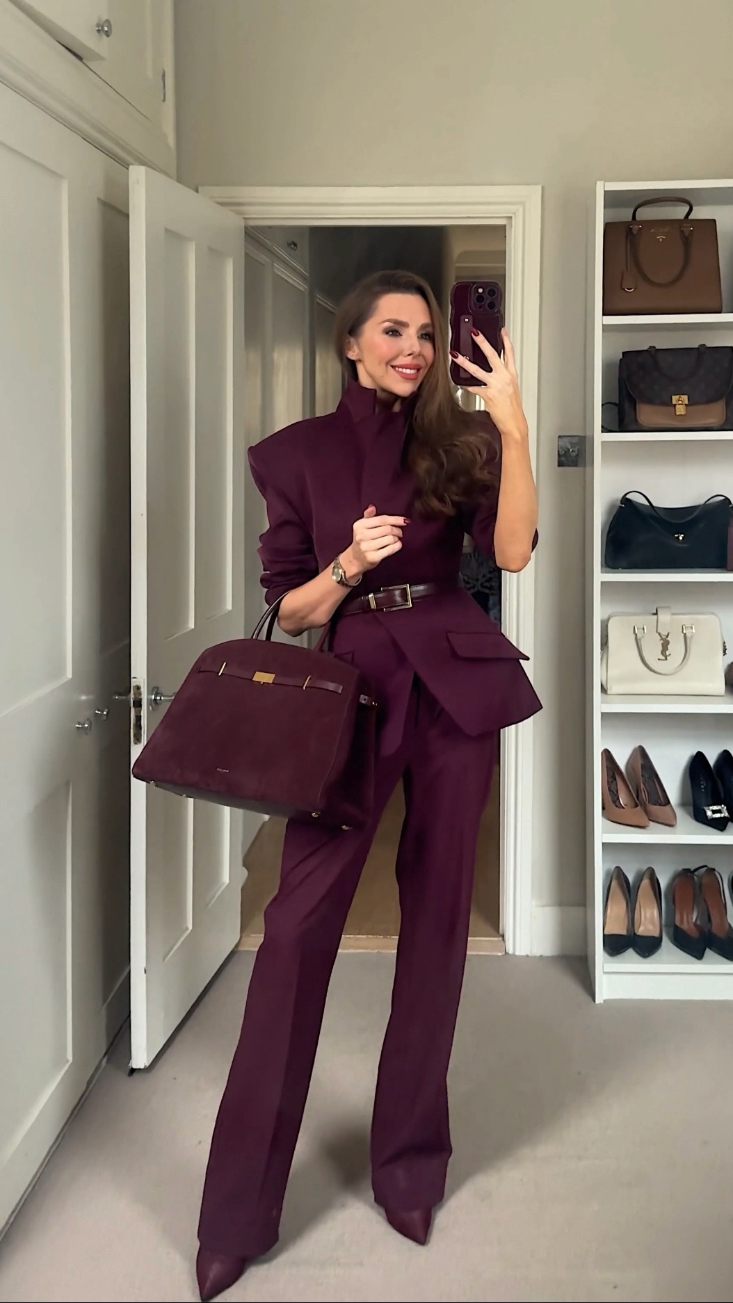 A maroon peplum blazer with a cinched-in waist creates a flattering, sculpted silhouette, styled with matching maroon tailored trousers and coordinating maroon boots for a sleek monochrome look. Finished with a maroon Demellier suede tote bag, this elevated outfit feels polished, confident and timeless, perfect for smart daytime dressing, workwear styling or refined evening occasions.

#LTKwinter #LTKfestive #LTKuk