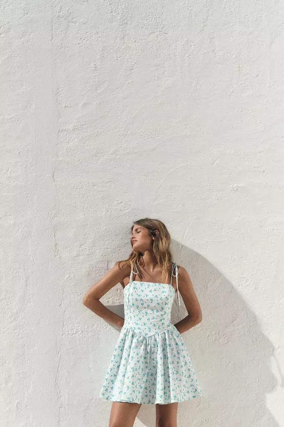 Short dress with a straight neckline and tie straps. Featuring side in-seam pockets, pleat detail... | Zara UK