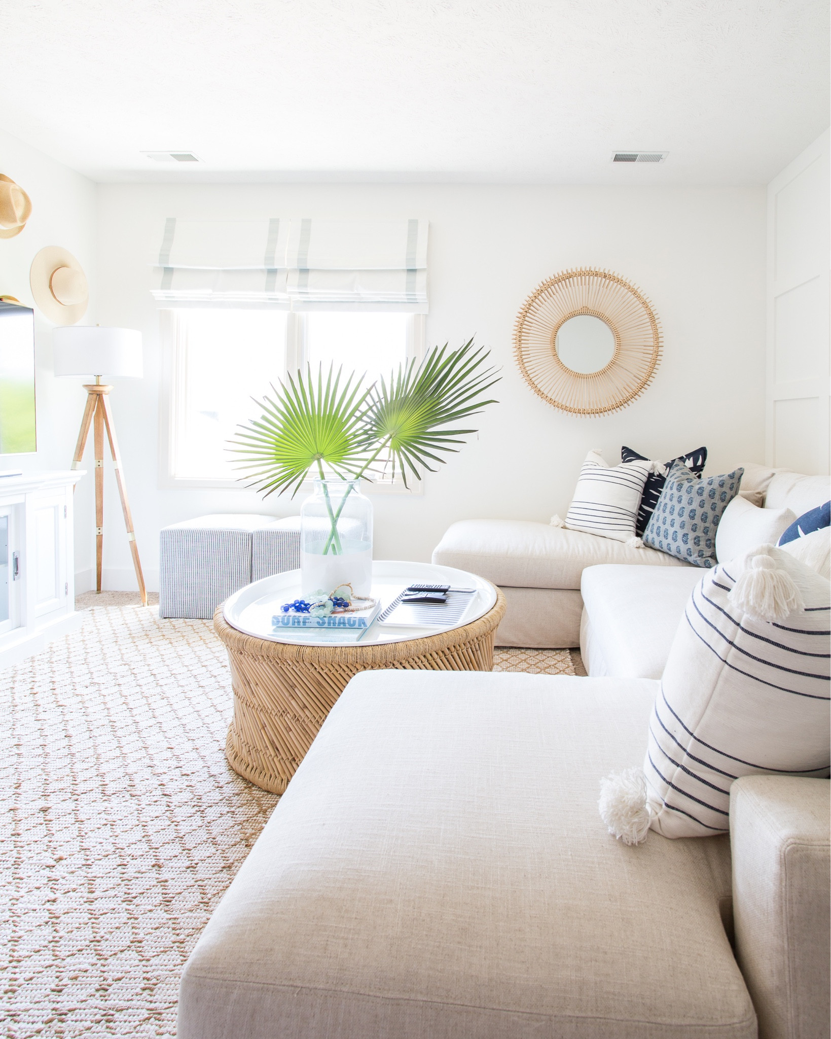 Our light and bright den decorated for spring or summer.  Neutral design items include several colors and patterns of pillows, a paint dipped vase filled with faux palm branches, a slip-covered sectional, a round bamboo coffee table, a jute area rug and fabric roman shades. Other items include blue and white striped poofs, a wicker mirror, a tripod lamp and a scalloped flush mount light. 

simple decor, spring décor, summer décor, Lynwood square upholstered, target threshold, studio mcgee threshold, neutral decor, coastal decorating, coastal design, den, family room, living room area rug, rugs family room, living room inspo, Serena and lily coffee table, studio mcgee threshold, target home décor, den rugs, serena and lily rugs, pottery barn shades, rugs family room, serena and lily pillows, etsy finds, etsy pillows, living room inspiration, game room, media room, round wall mirror, serena and lily, pottery barn sofa, family room pouf, media room, wall decor, coffee table decor, family room decor, amazon finds, target finds, studio mcgee target, coastal inspiration #ltkfind 

#LTKSeasonal #LTKstyletip #LTKunder50 #LTKunder100 #LTKsalealert #LTKhome #LTKfamily #LTKSeasonal #LTKfamily #LTKstyletip