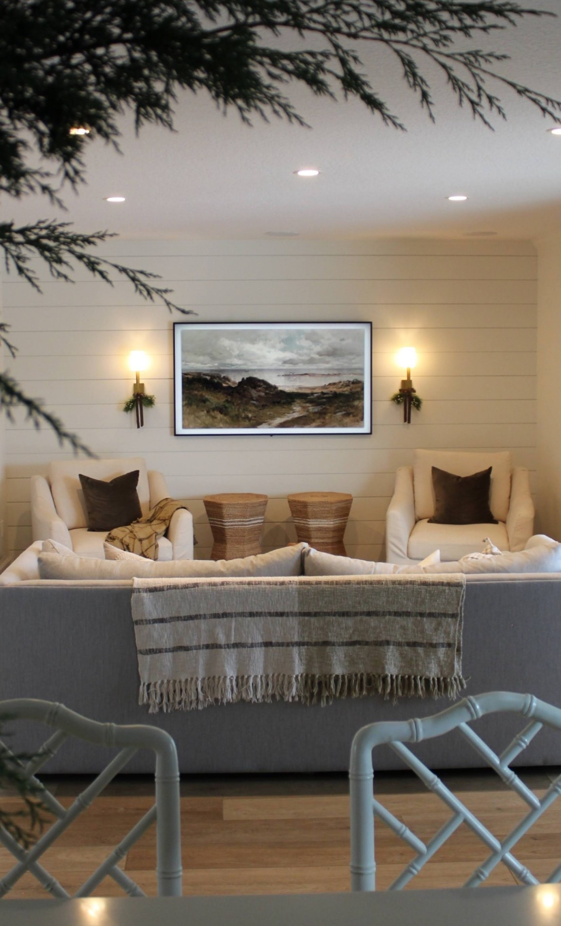 Christmas Past living room decor 
Pine swags with brown ribbon frame tv art pillow covers wall sconces lighting 

#LTKHoliday #LTKHome #LTKSaleAlert