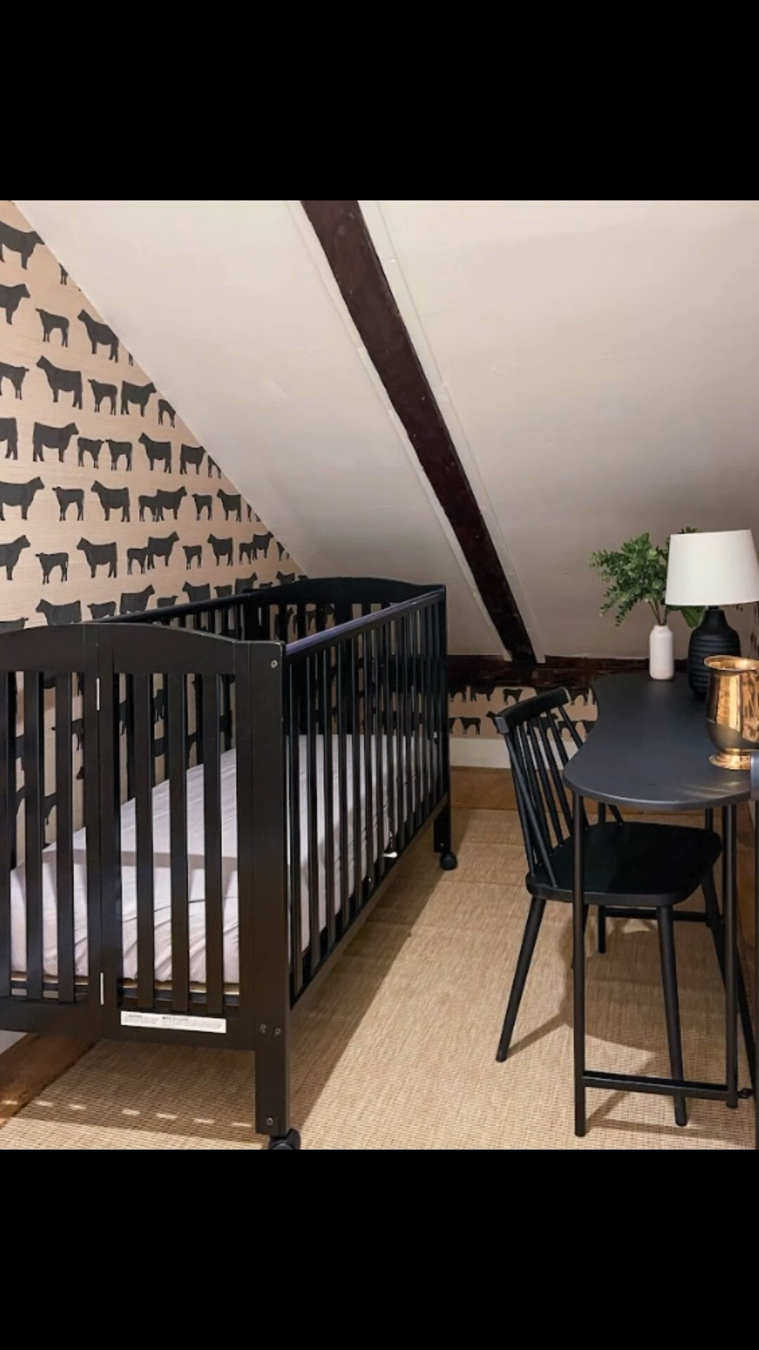 Closet nook with cow print wallpaper, a black crib, woven rug, black desk and windsor chair. The cow print wallpaper was originally added so this space could work as either a baby room, office nook, or flexible overflow space depending on how the room is being used. Linking exact and similar pieces here.

#LTKHome #LTKSaleAlert