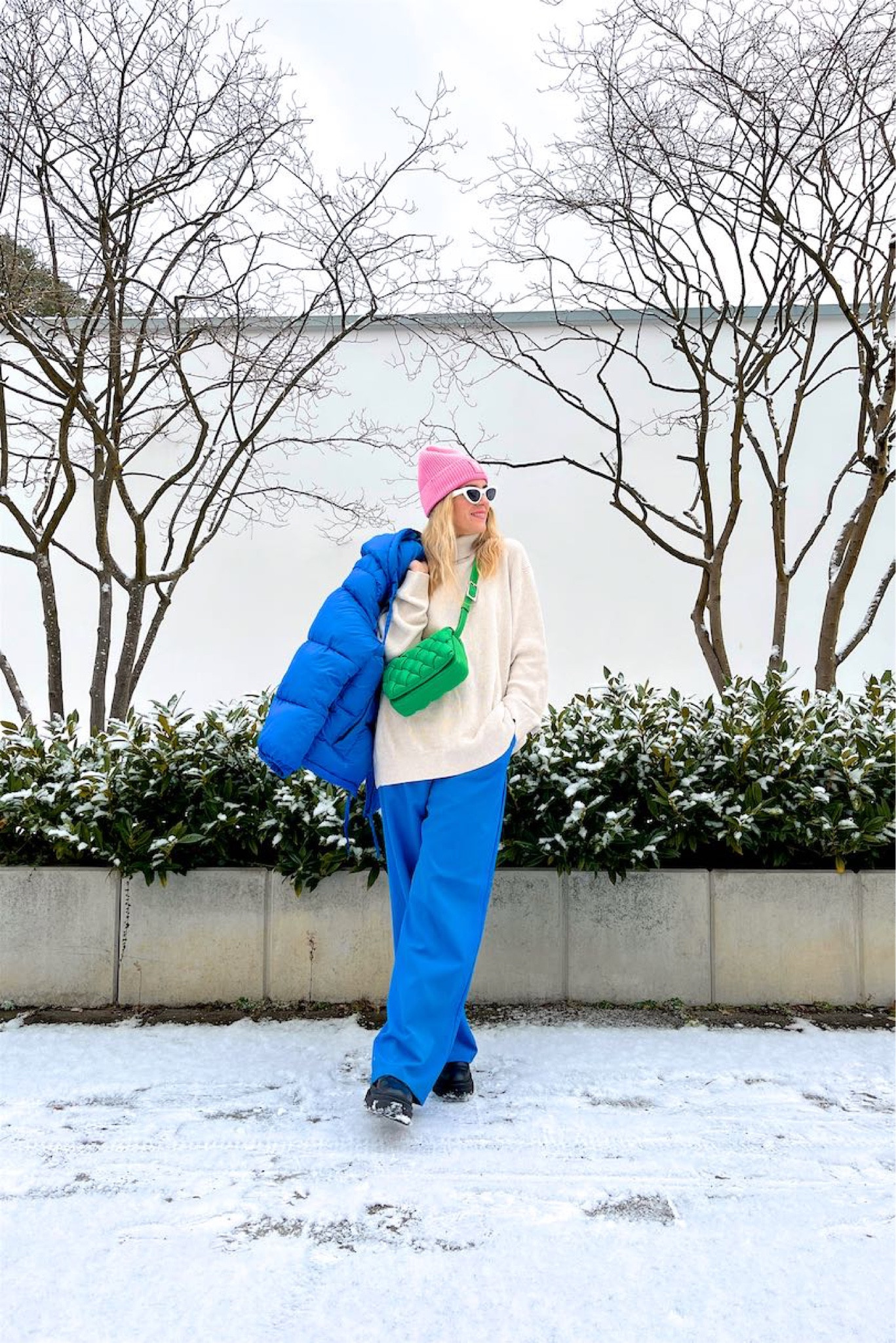 Color Trio. Fashion Blogger Girl by Style Blog Heartfelt Hunt. Girl with blond hair wearing a pink beanie, white cat-eye sunglasses, blue down jacket, oversized turtleneck, blue wide leg pants, green braided bag and chunky boots. #colorfuloutfit #colorfulstyle #colorfulfashion #colorfullooks #fashionfun #cutefalloutfit #fallfashion2022 #falllookbook #fitcheck #dailylooks #dailylookbook #contentcreator #microinfluencer #discoverunder20k 