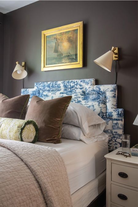 Cozy classic bedroom with the best brown paint color, sconce lights, bedroom pillows, beige quilt coverlet, and vintage painting 

#LTKhome #LTKstyletip #LTKfindsunder100