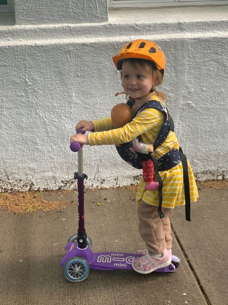Toddler wearing baby doll carrier, riding scooter with helmet. ❤️

#LTKbaby #LTKkids #LTKfamily