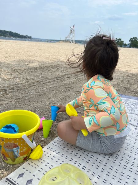 Beach adventures with my little one 🏖️👶 Having a splashing good time as my toddler plays with a beach bucket on a comfy playmat, all set in a cute rash guard for some sun-safe fun! ☀️🏄‍♂️ #BeachBabies #ToddlerFun #SunSafePlay 

#LTKSeasonal #LTKfamily #LTKbaby