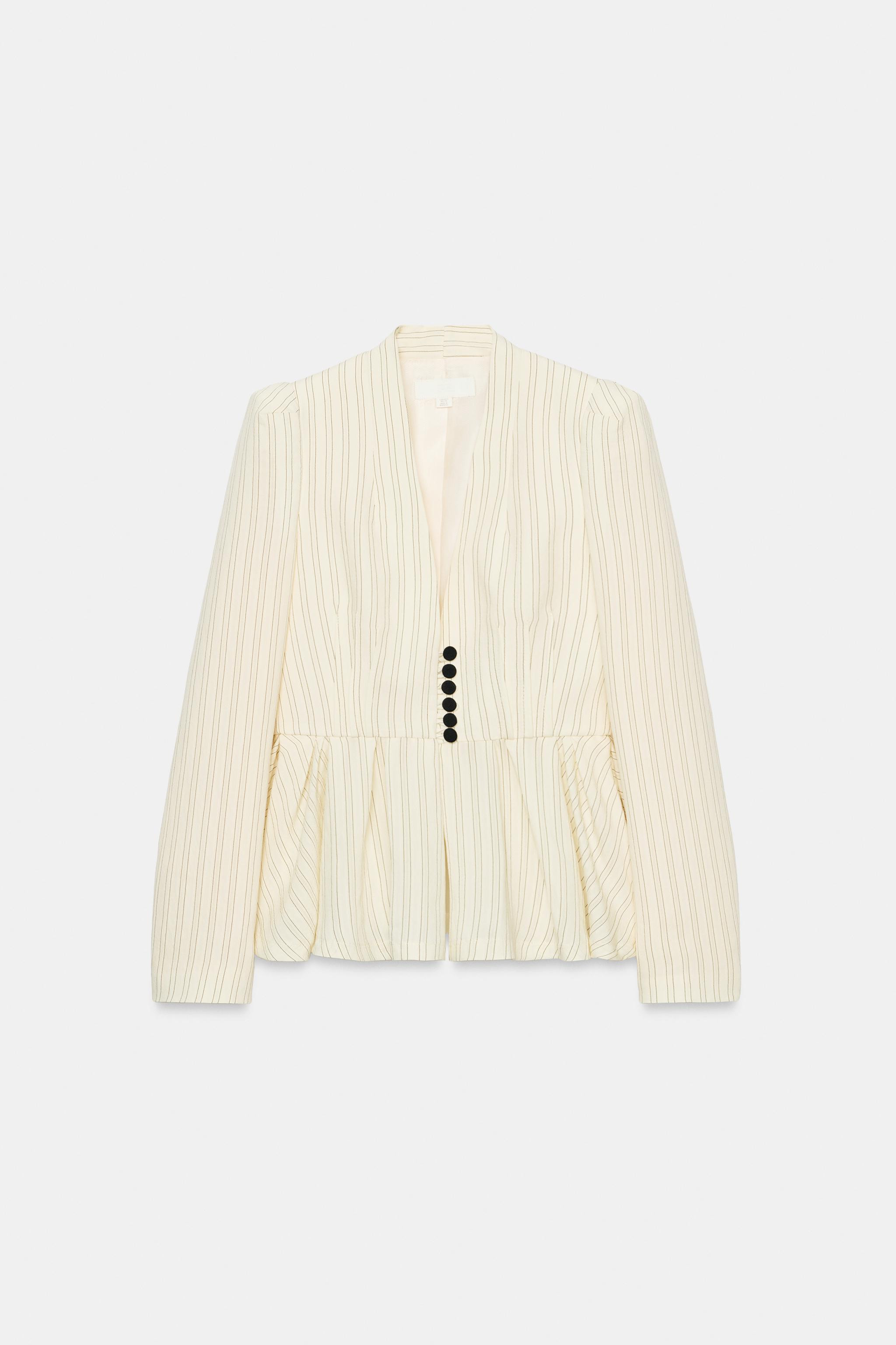 Blazer with a collarless neckline, long sleeves and shoulder pads. Featuring a flared hem with pl... | Zara UK