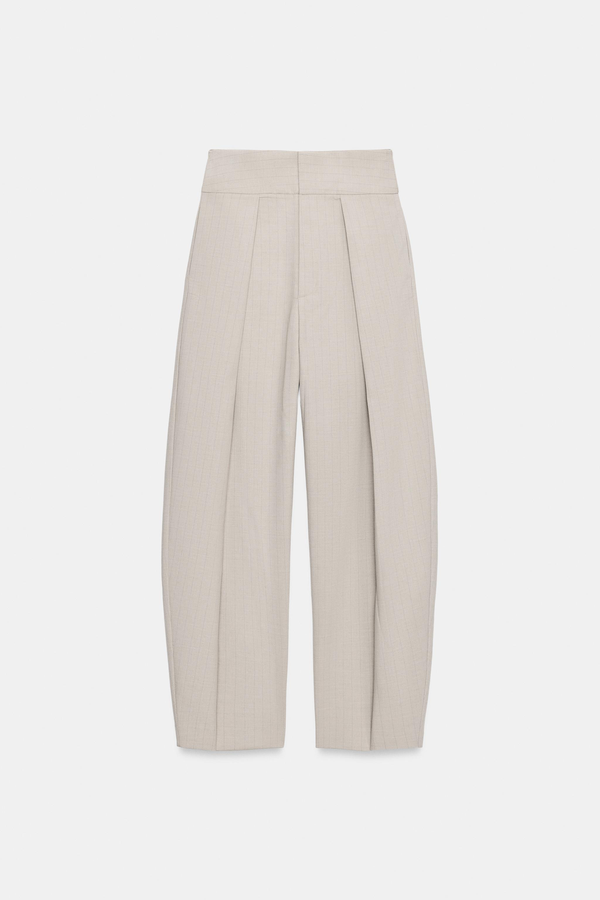 Model height: 181 cmHigh-waist trousers made from a viscose blend. Featuring front pleats, side p... | Zara UK