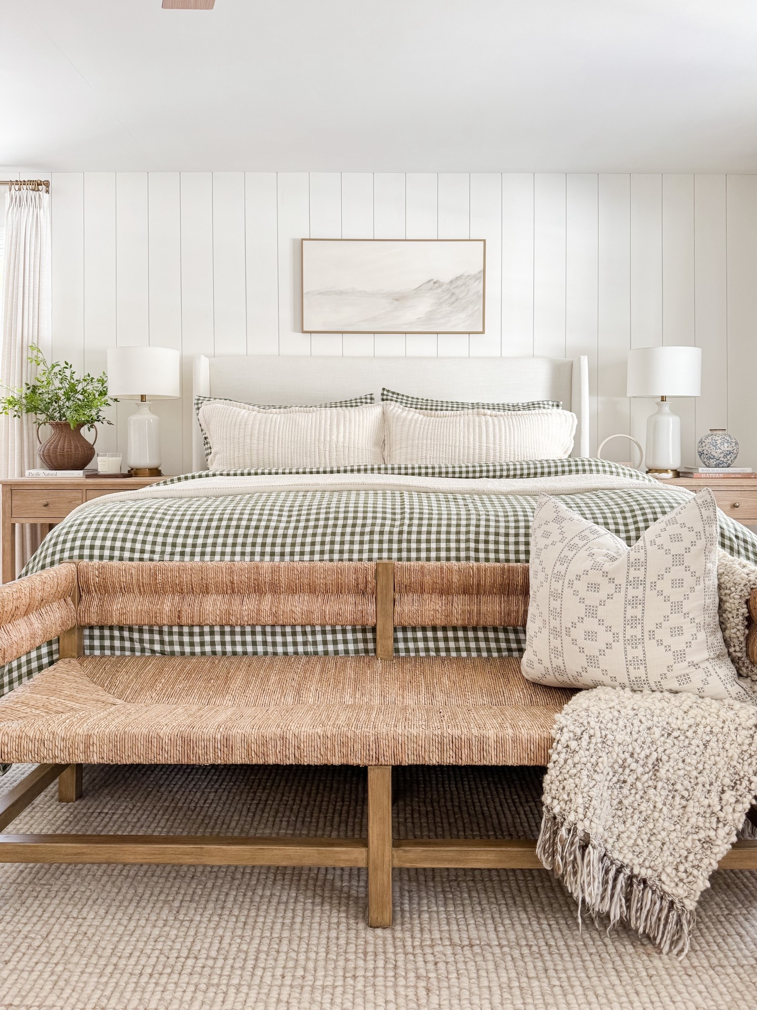 Neutral coastal bedroom with gingham bedding, layered throw blankets, textured knit coverlet, and soft patterned pillows. Light wood nightstands and white table lamps create a calm, layered spring bedroom look. 
gingham bedding, neutral bedroom decor, layered bedding, spring bedding, coastal bedroom, throw blanket, knit coverlet, patterned pillows, light wood nightstands, white table lamps, cozy bedroom, serene bedroom style, sherri calnan home

#LTKHome