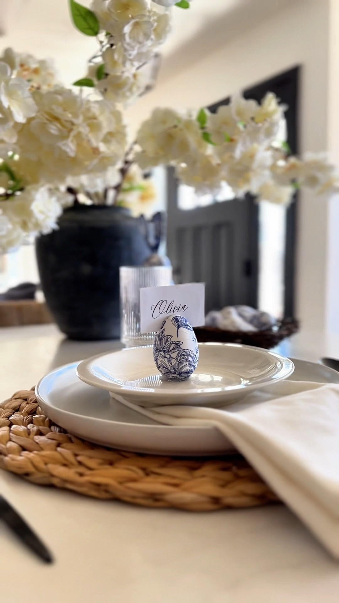 The easiest DIY Easter hack that takes just a few minutes. I’ve linked everything I used. DIRECTIONS:
1. Find a cute paper napkin (I linked mine), remove the top ply, and cut out smaller designs that you like from the napkin. Set aside. 
2. Paint a layer of ModPodge on a craft egg. 
3. Add the napkin pieces and paint another layer of ModPodge on top. Let dry. 
4. Print or write a place card. 
5. Cut a small slit on top of the egg.
6. Add a generous amount of hot glue on the bottom and stand on wax paper. 
7. Add the card in the slit and set on your table setting. 

🏷️ Easter table , Easter tablescape , Easter DIY , place cards , table setting , cotton napkins , plates , plate chargers , ribbed glasses 


#LTKSeasonal #LTKHome #LTKU