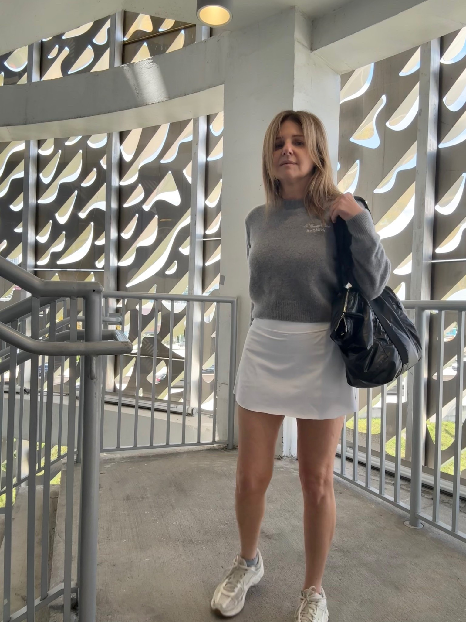 Wearing a flat front, no pleats skort from Athleta size: S, length 13.5” w my Sporty & Rich cashmere cropped sweater + gray ruffle ankle socks and a shiny black tote bag. Athleisure / post-tennis, Padel, pickleball outfit.

#LTKootd #LTKActive #LTKSeasonal