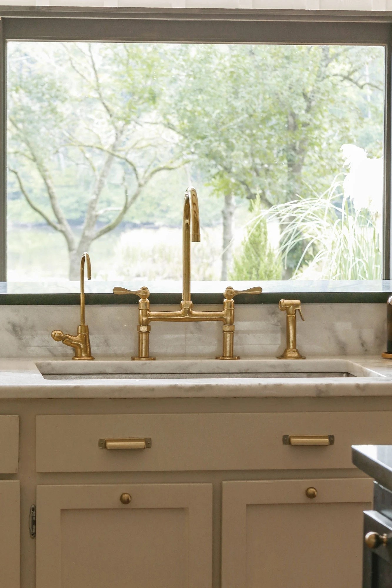 Love the look of the Rejuvenation (or deVOL) unlacquered brass bridge faucet but not the piece tag? I found the perfect dupe for a small fraction of the cost!  #faucet #brass #kitchen #brassfaucet #rejuvenation #dupe #decor 

#LTKStyleTip #LTKHome