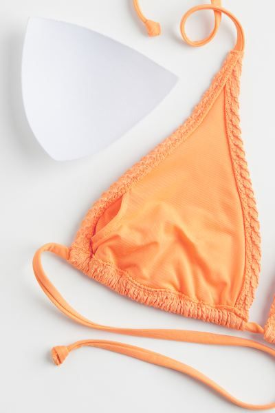 Lined, soft-cup triangle bikini top with a textured surface. Narrow ties at back of neck and at b... | H&M (US + CA)