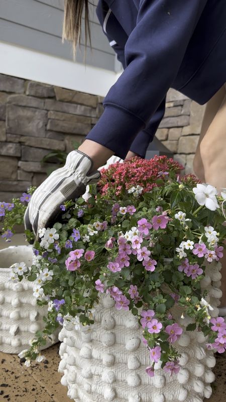 Spring is in full bloom (yayy!) and it’s time to freshen up our outdoor planters! These white ceramic planters are so fun with the pompom texture. I love that they come as a set of 2 for a layered look. I like to add in other pots too for a collected feel. 

They were the perfect addition to my front porch & I want to add some to my back porch too. My back patio is due for a refresh!!

#LTKhome #LTKSeasonal #LTKVideo