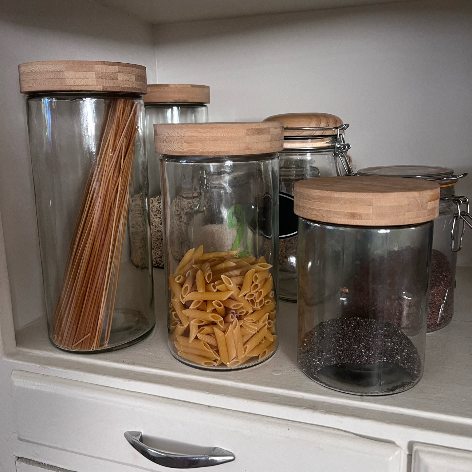 Love with glass canisters with bamboo screw on tops for dry goods