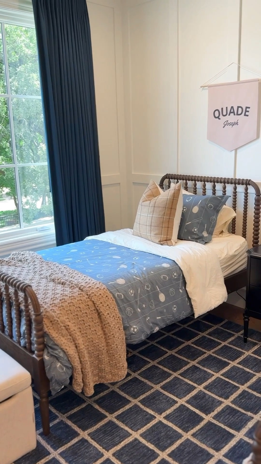 Quade + Beauden’s Equestrian Room 🐎
Think Ralph Lauren meets boyhood. This shared room is layered with warm woods, classic plaids, and tailored details that nod to an equestrian, prep-school vibe while still being kid-friendly.

Paint is grounded and moody, the custom linen drapes elevate the space, and the mix of textures — from the Jenny Lind spindle bed in deep brown to the woven dome pendant and faux leather caramel lounger — keep it feeling both timeless and comfortable.

We tied in equestrian-inspired accents through plaid pillows, vintage western artwork, and rich leather tones that will grow with them. Storage pieces like the Delancey dresser and Cassian nightstand finish the look with polish.

The result: a boys’ room that’s sporty yet refined, playful yet elevated — a space that can carry them from childhood to young adulthood.

✨ Shop the full room here 