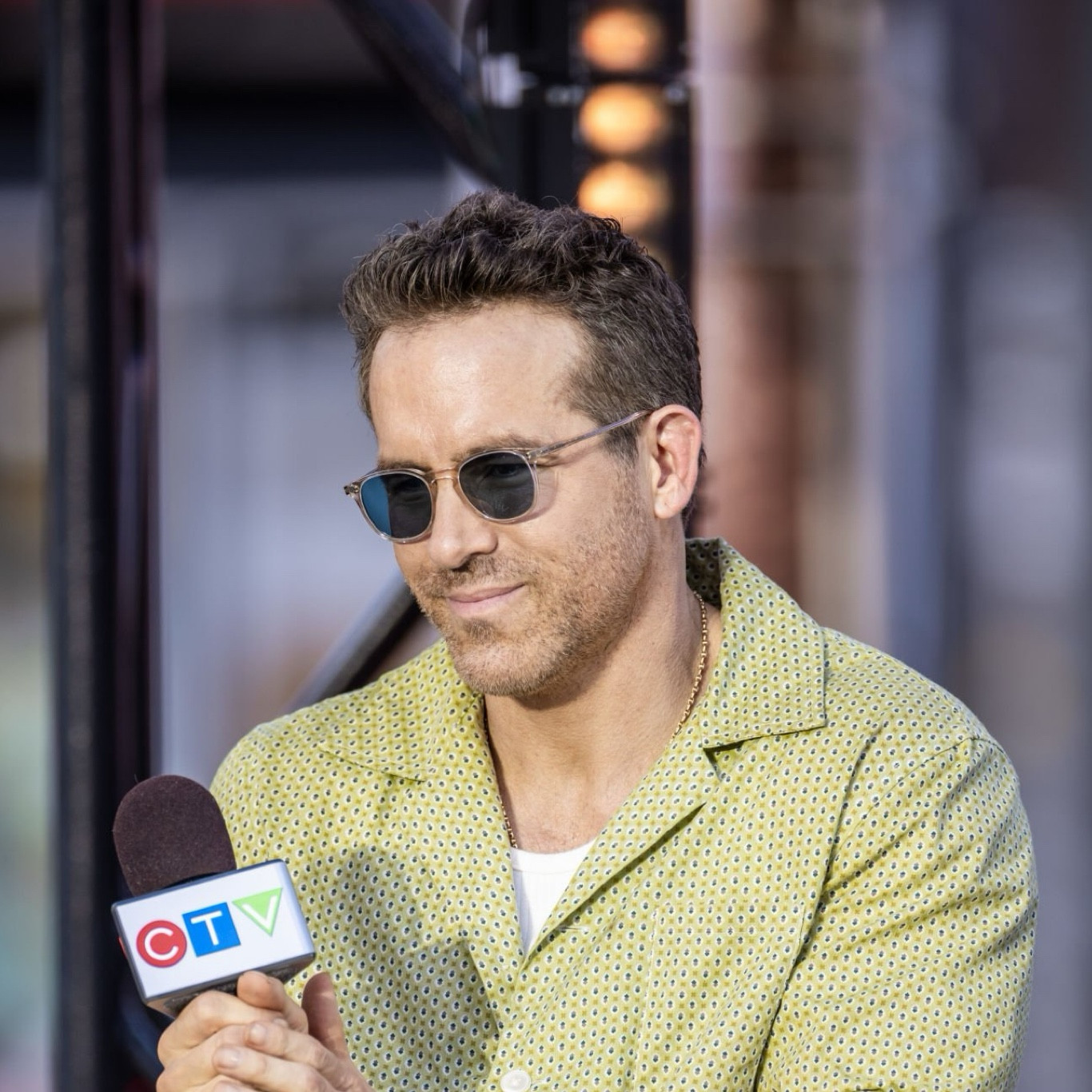 Ryan Reynolds in Toronto with taping Etalk for Deadpool & Wolverine wearing sunglasses with clear pink frames and teal blue lenses  