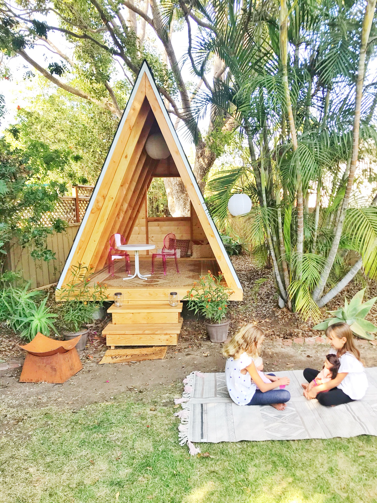 Getting ready for a kids birthday party and we are sprucing up our backyard Aframe playhouse.  These kids ghost chairs that we have in our playhouse are the cutest!  We add some outdoor rugs around to encourage kids to play and hangout outside.  

#LTKkids #LTKhome #LTKparties