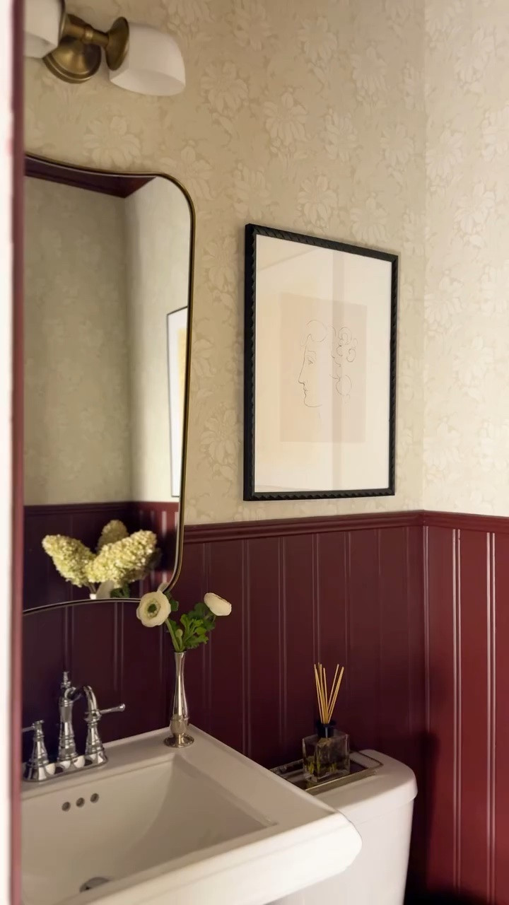 I love using small spaces as an excuse to go big. This moody half bathroom came together with neutral floral wallpaper, beadboard painted in SW Rookwood Dark Red, and a few textured accents.

The large-scale art from @artfullywalls is what ties everything together — it grounds the space, adds depth, and instantly makes it feel finished instead of forgotten.

Comment SHOP for a direct link to the pieces I used in this space. 

#powderroomdesign #halfbathmakeover