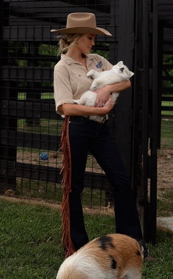 Brittany Aldean wearing a Ford Mustang button front short sleeve Kamp shirt, fringe denim jeans, woven boots ￼