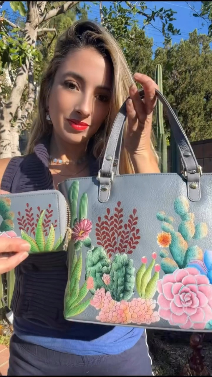 Do you carry art… or just a handbag? 🎨✨

I am obsessed with this hand-painted Anuschka tote and matching wallet. Every detail is literally painted by hand — the colors, the texture, the little cactus and floral details — it feels like carrying a piece of wearable art. By @anuschkaleather @ltk.creators 

What I love:

✨ Genuine leather
✨ Individually hand-painted (no two are exactly the same)
✨ The medium tote is the perfect everyday size
✨ The accordion wallet keeps everything organized but still compact

It’s one of those pieces that instantly elevates a simple outfit and becomes a conversation starter.

I love accessories that feel personal — not mass produced.

👇 Are you more of a neutral bag girl or do you love statement pieces like this?

#Anuschka #HandPaintedLeather #StatementBag #ArtYouCanWear #LTKCreator

#LTKSaleAlert #LTKgrwm #LTKootd