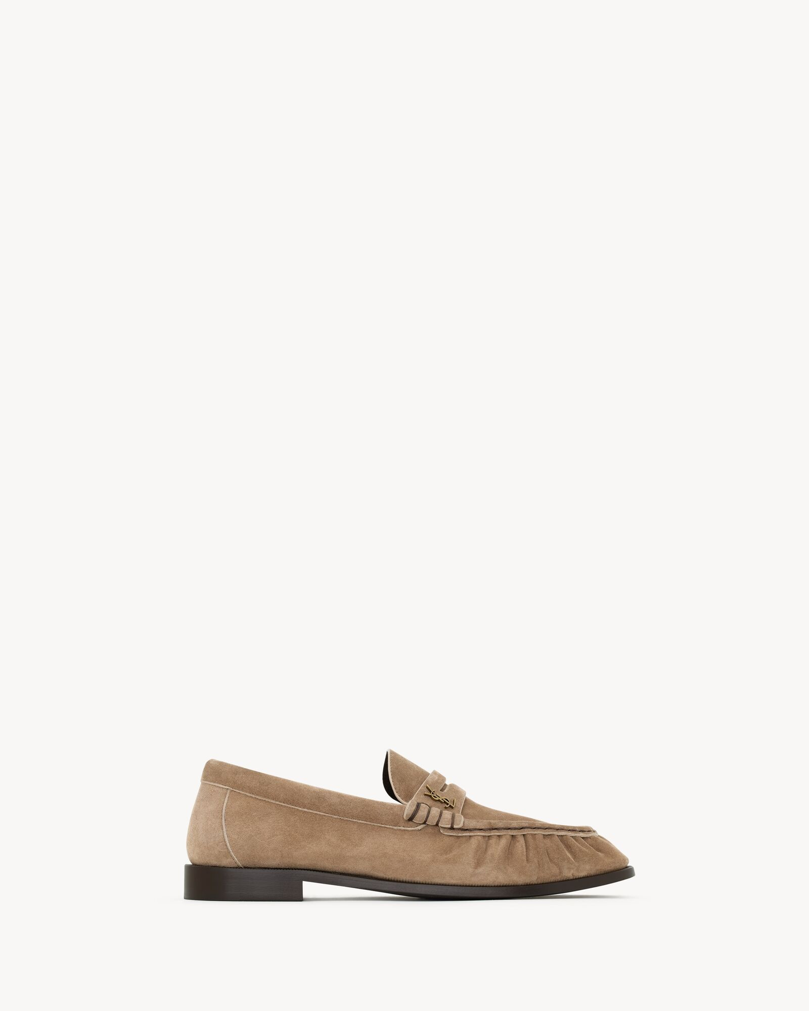supple penny loafers decorated with the CASSANDRE, featuring a hand-stitched moc toe. | Saint Laurent Inc. (Global)