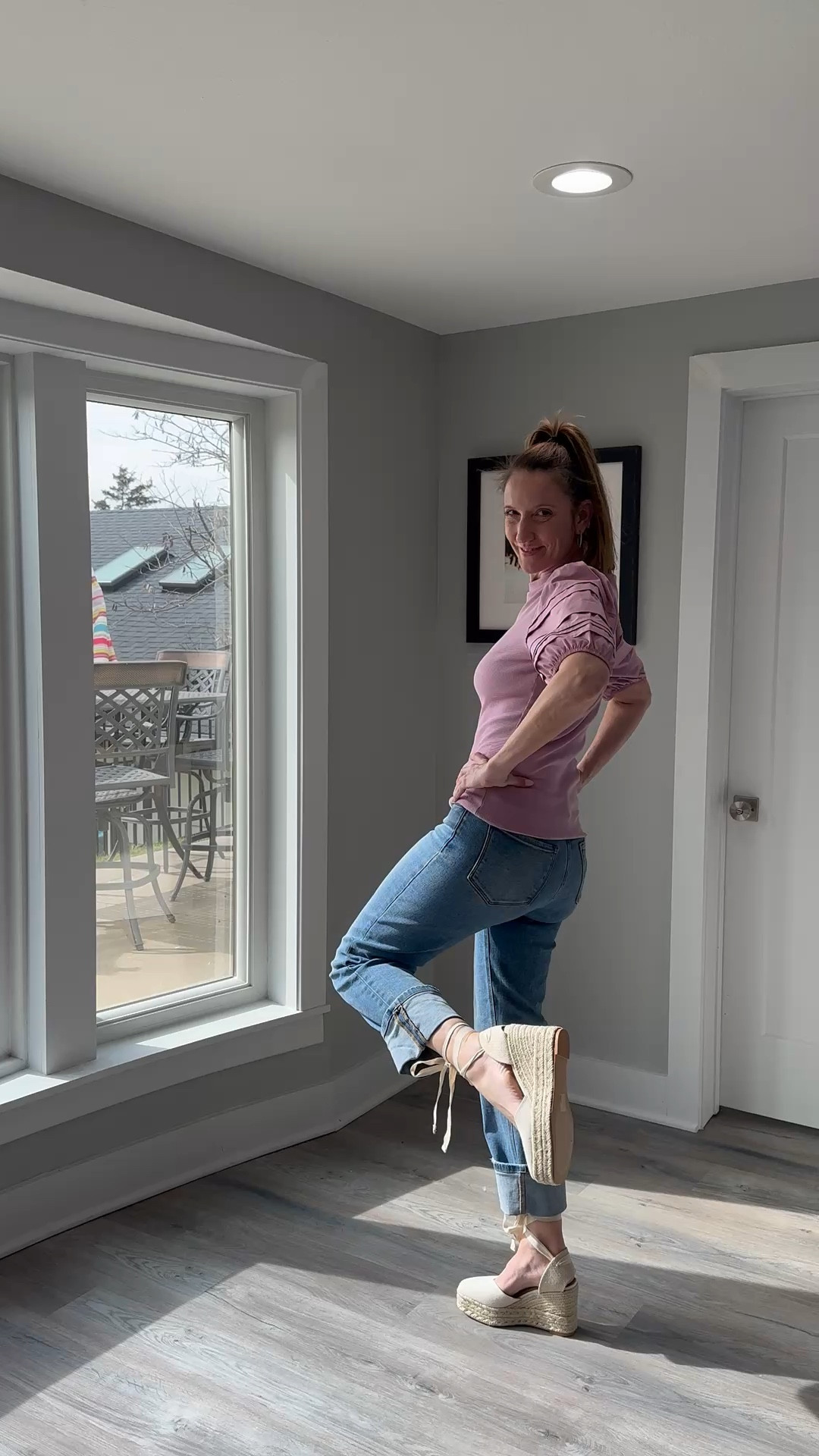 The puff sleeve detail on this lavender knit is such a simple way to elevate your favorite pair of jeans. 🌸✨ I love how the soft, dusty rose hue pairs with these lace-up wedges for an effortless spring morning. Shop this exact look and more of my seasonal favorites at the link in my bio! #SpringStyle #PuffSleeves #LaceUpWedges #ShopTheLook @VICI 

My Pastel Knit Style Breakdown
• The Top: I’m wearing a short-sleeved, crewneck knit top in a dusty lavender or mauve shade, featuring dramatic pleated puff sleeves that add structure to the shoulders.
• The Denim: I’ve paired the top with medium-wash straight-leg jeans that I’ve styled with an extra-deep cuff at the ankle.
• The Footwear: I finished the look with my cream-colored lace-up espadrille wedges, tying the ribbons over the denim cuffs for a modern silhouette.
• The Hair: My hair is pulled into a high, textured ponytail with a black scrunchie, keeping the focus on the sleeve details and the neckline.
• The Vibe: This outfit is the definition of "polished casual"—it captures the freshness of spring through soft colors while remaining practical for a busy day.

Lavender puff sleeve top, mauve knit shirt, pleated shoulder top, cuffed straight leg jeans, medium wash denim, cream espadrille wedges, lace up ribbon sandals, spring casual outfit, feminine weekend style, pastel spring fashion, LTKstyle

#LTKOver40 #LTKootd #LTKgrwm