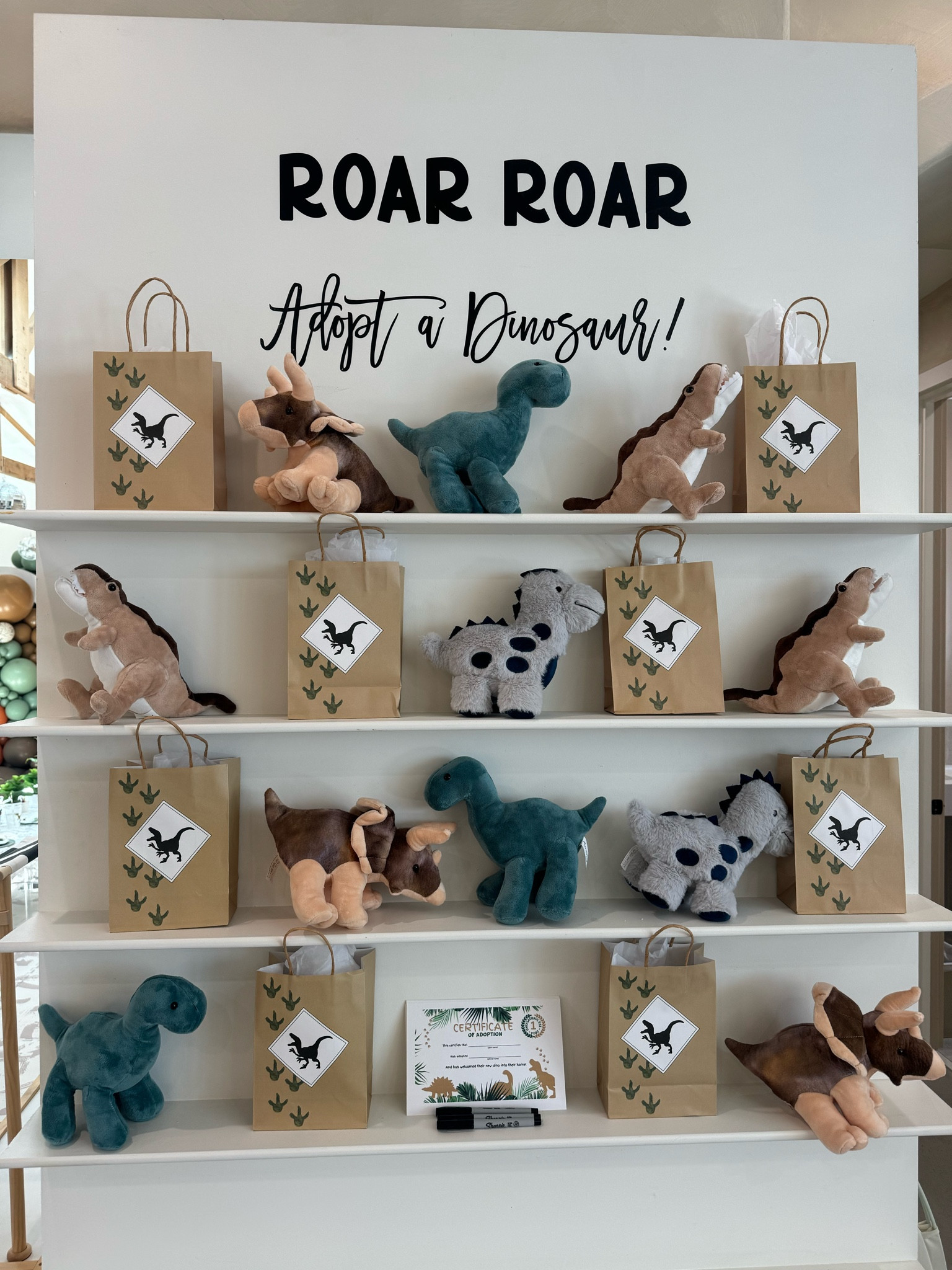 Dino birthday party favors! Dino stuffed animal and Dino pop it fidget in party bags! 