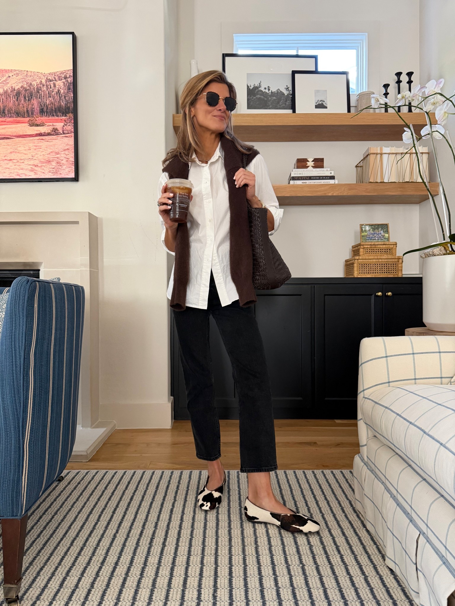 White button up blouse with Abercrombie black denim + cashmere brown pullover and madewell cow print flats 