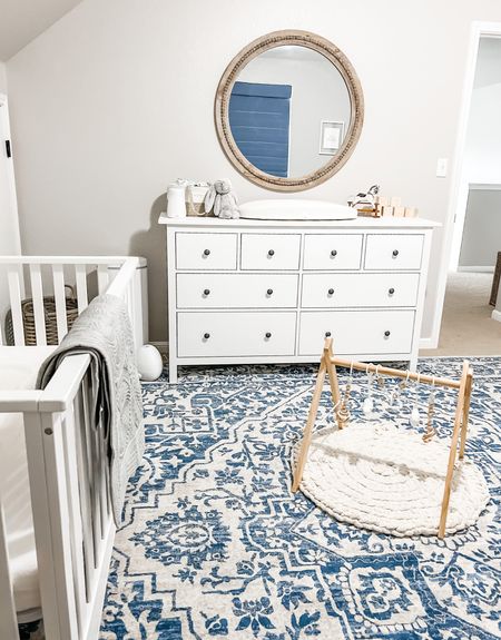 Simple baby boy nursery style. White nursery furniture with blue and grey accents. White crib, blue rug, large round wall mirror. Natural wood play gym for infants. 

Target crib, Amazon decor, jelly cat stuffed animals

#LTKbump #LTKhome #LTKbaby