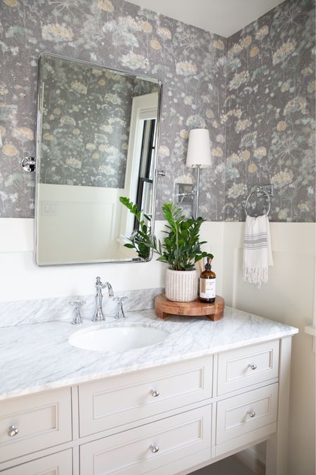 Our powder room bathroom! We have wainscoting (painted simply white) paired with this pretty gray floral wallpaper. The vintage rounded tilt mirror from Pottery Barn is still in stock and on sale, but I also found a look for less on Amazon! ￼Our pretty gray vanity with marble top is now only available in white but I linked a few other gray options too. I love the classic and timeless look of this bathroom then the wallpaper as a pop of fun to the space!

#LTKsalealert #LTKstyletip #LTKhome