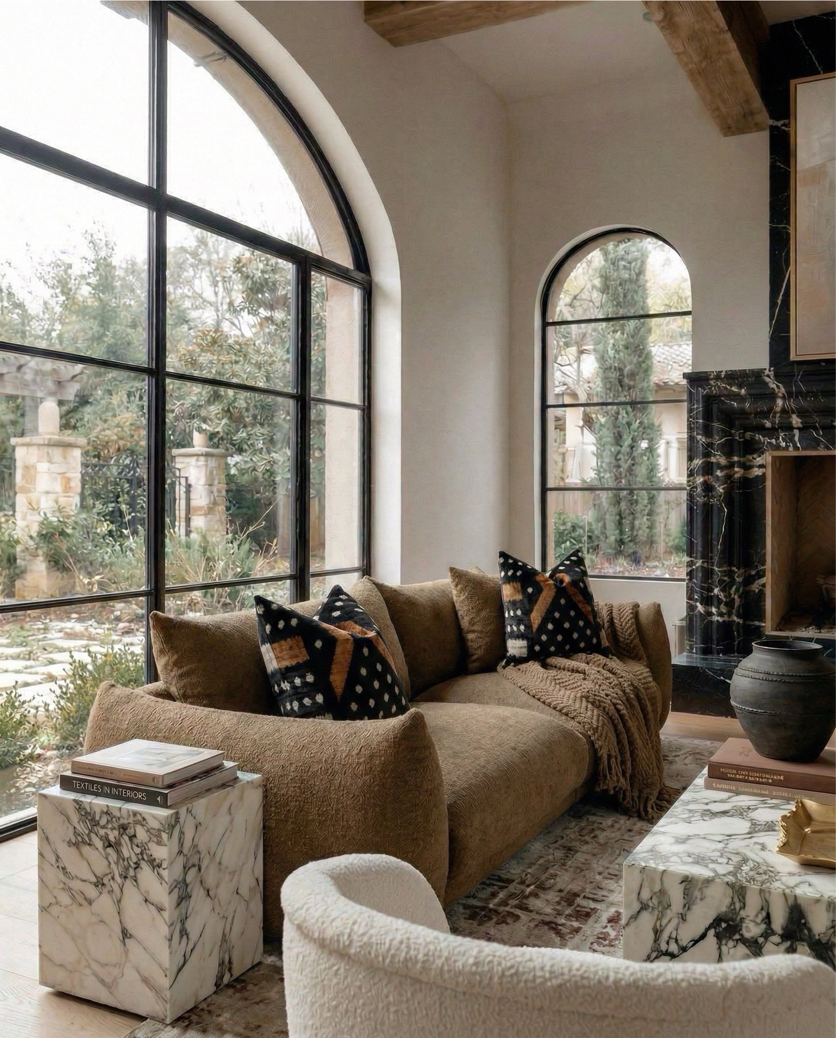 Shop the look
•Brown boucle sofa
•Marble coffee table
•Marble end table
•brass tray
•Black terracotta vase
•Brown decor books
•Brass leaf decor bowl 
•Brown vintage rug
•black and brown throw pillow
•brown knitted throw blanket
• white boucle swivel accent chair
•abstract wall art

#LTKHome #LTKSaleAlert