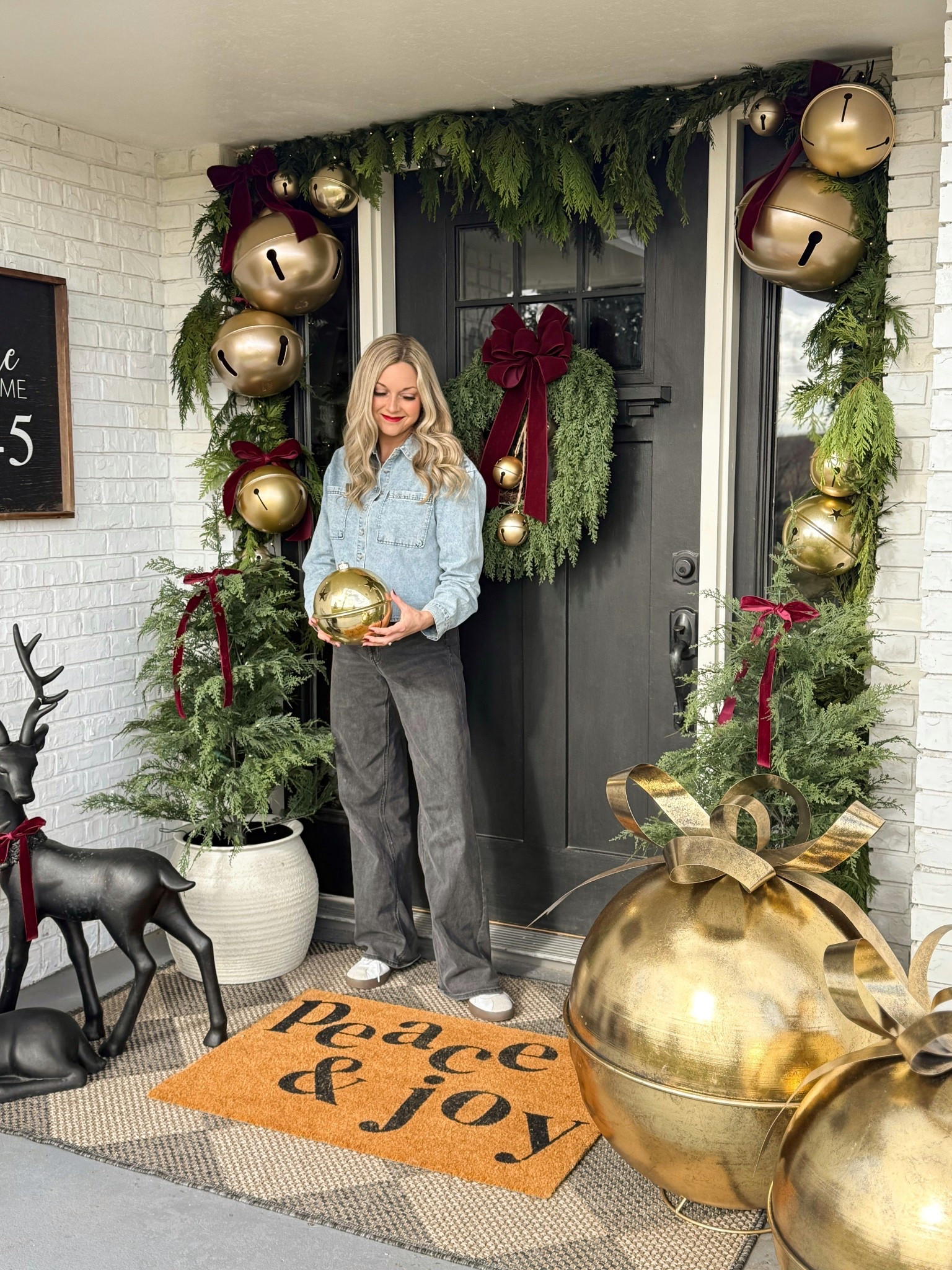 Holiday front porch!  
DIY Oversized Jingle Bell Garland. 🔔❤️ 
Some are spray painted red bell with Gilded Brass. 