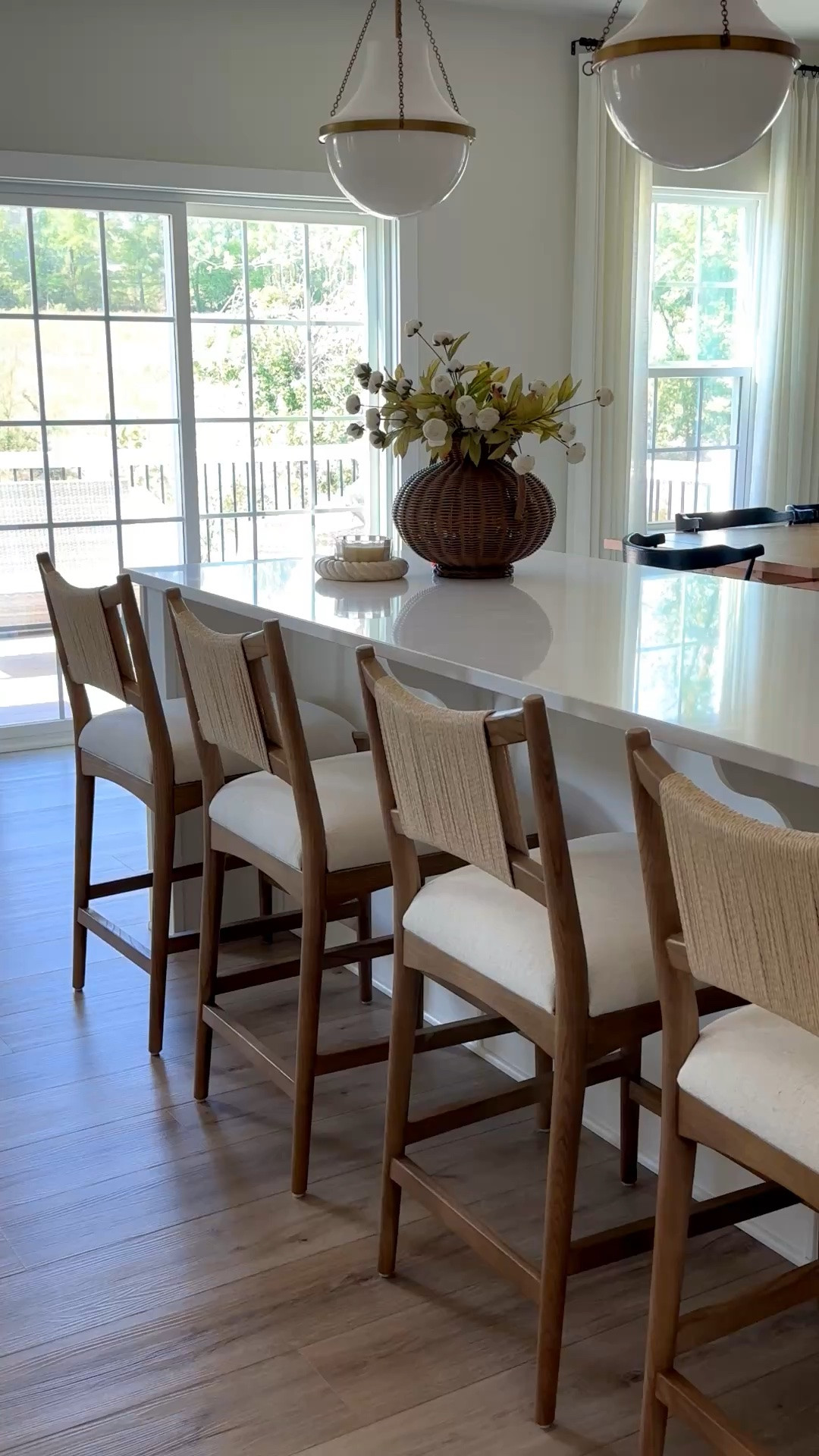 The soft brass hardware and wood tones warm up our all white kitchen. 
#kitchenhardware #counterstools #whitekitchen #pendantlights

#LTKHome