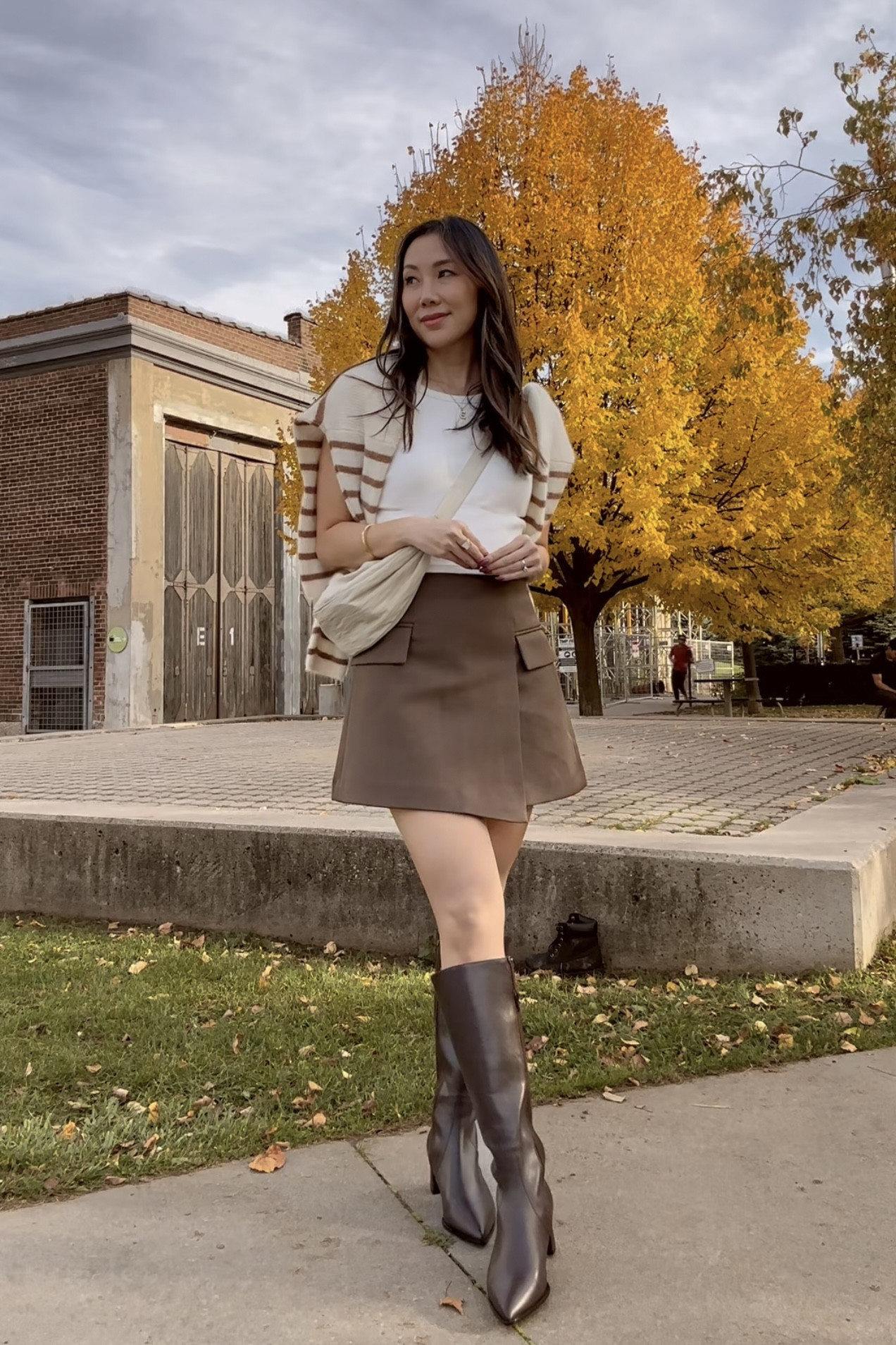 Keeping it chic and cozy with this layered look! I’m wearing a Uniqlo tank top with a built-in bra for effortless comfort, paired with a classic striped cardigan from Sézane and a brown mini skirt from Chicwish (bonus: it has built-in shorts!). Finished off the look with knee-high tall boots from Allie Shoes to add a touch of elegance. This outfit is the perfect mix of style and practicality for those cooler days. What do you think of this combo? #FallOutfit #OOTD #LayeredLook

#LTKSeasonal #LTKStyleTip #LTKCyberWeek