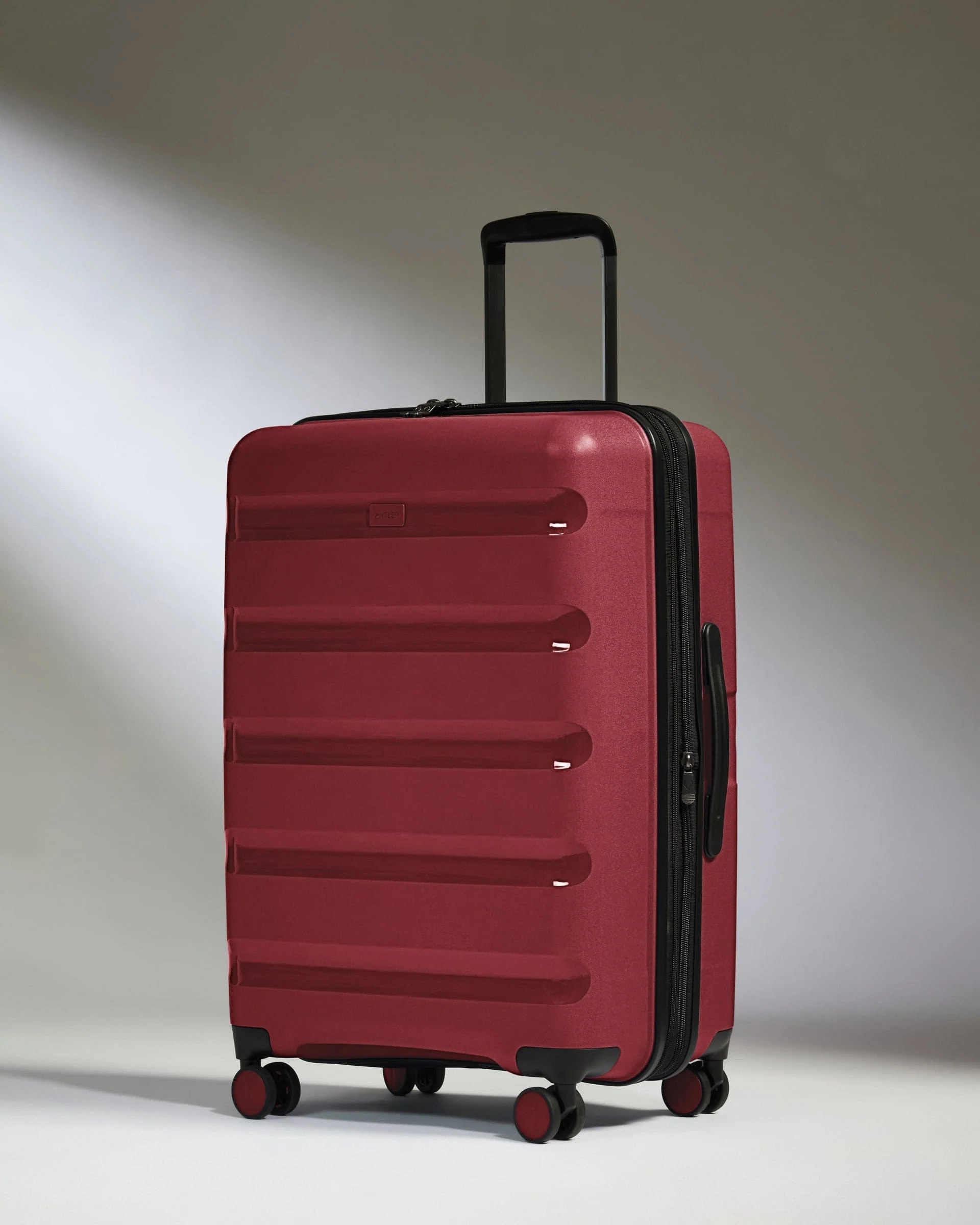 Medium Suitcase Red - Logo Stripe | Lightweight Hard Shell Luggage | Antler UK