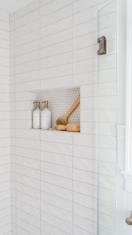 White coastal style bathroom with white subway tile and decorative tile, glass shower enclosure, bathroom accessories

#LTKhome #LTKfamily